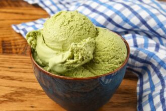 green tea ice cream in bowl bowl on wooden table