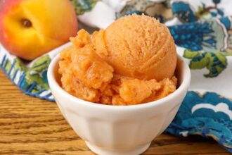 peach sorbet in white bowl on table