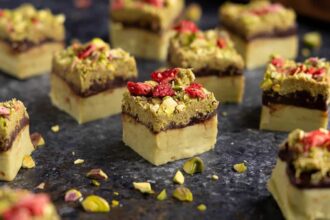 pieces of Dubai Chocolate Fudge with a pistachio base, chocolate ganache layer, and a kataifi topping/