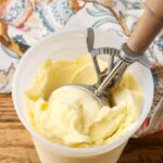 wooden ice cream scoop in container of ice cream