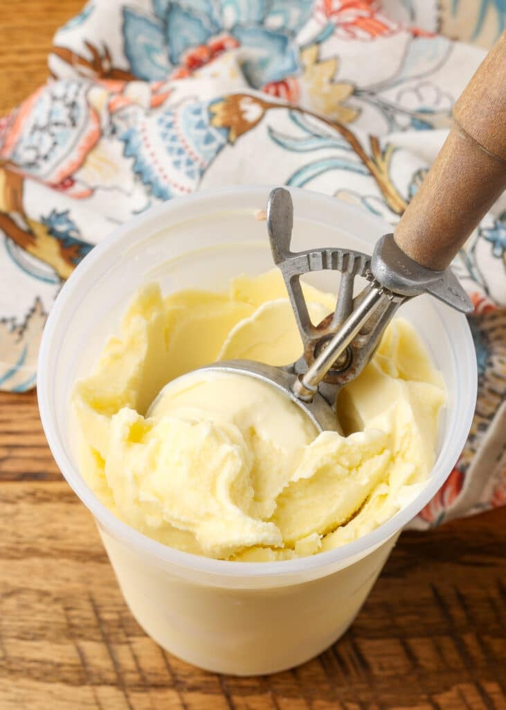 wooden ice cream scoop in container of ice cream