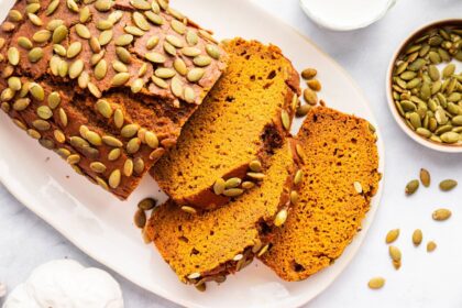 Sliced Starbucks pumpkin bread on a white plate showing fluffy, moist texture.