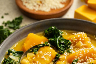 Spoon resting in a bowl of our 1-Pot Kabocha Chickpea Miso Soup