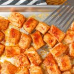 salmon bites with spatula on sheet pan