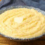 polenta in blue bowl topped with butter