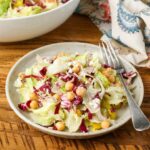colorful salad on pottery plate on wooden table