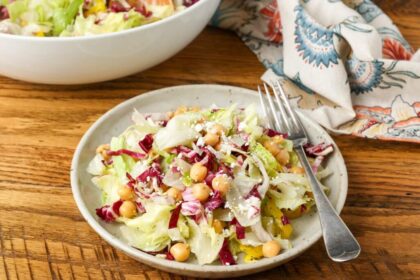 colorful salad on pottery plate on wooden table