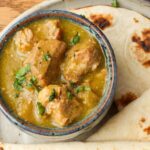 chile verde in bowl next to tortillas