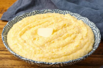polenta in blue bowl topped with butter