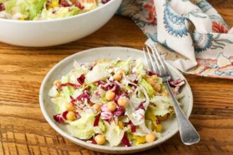 colorful salad on pottery plate on wooden table