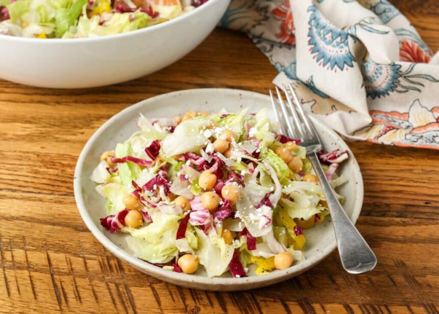colorful salad on pottery plate on wooden table