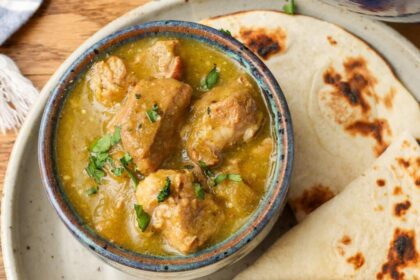 chile verde in bowl next to tortillas
