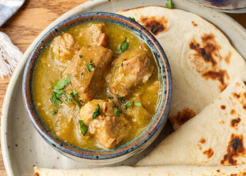 chile verde in bowl next to tortillas