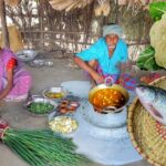 Cauliflower and Rohu Fish curry and onion leaves fry cooking by santali tribe ol couple for lunch